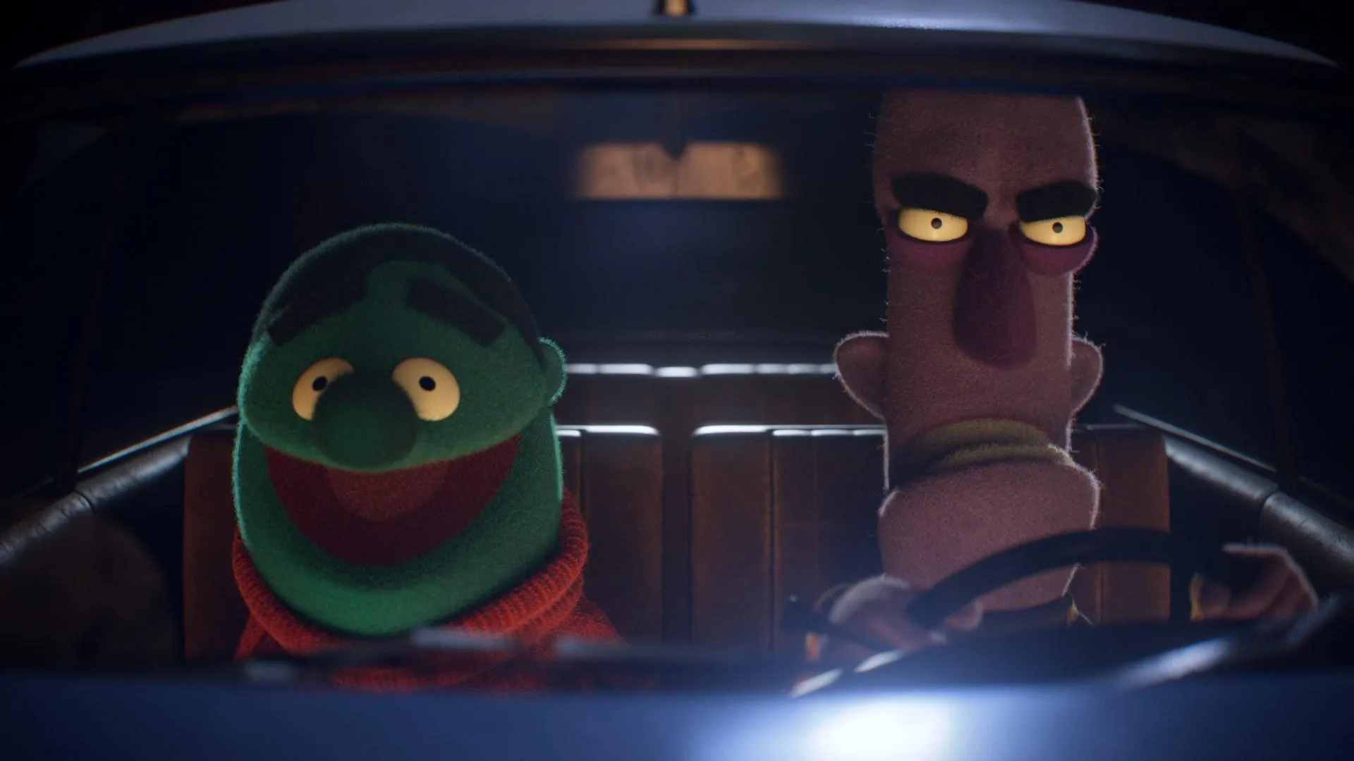 Two animated puppets with distinct expressions sitting in a car at night, created by 23lunes. Two animated puppets with distinct expressions sitting in a car at night, created by 23lunes.
